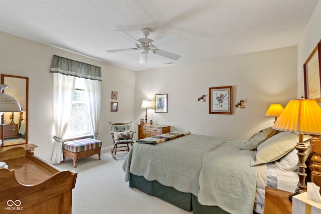 bedroom with ceiling fan, visible vents, and carpet
