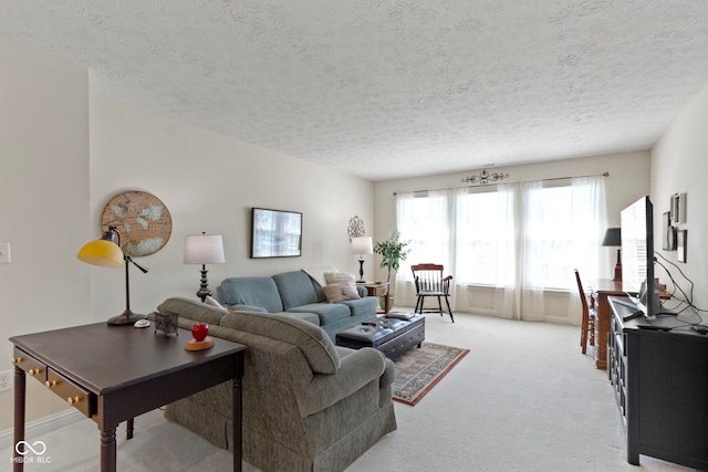 living area with a textured ceiling and light colored carpet