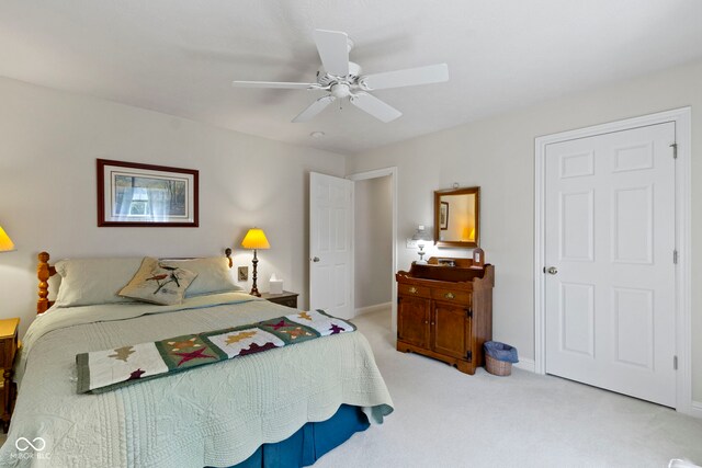 bedroom with baseboards, a ceiling fan, and light colored carpet