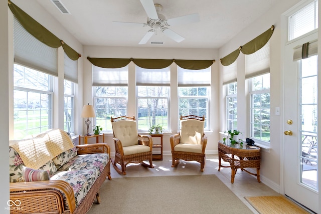 sunroom / solarium featuring baseboards, tile patterned floors, and visible vents