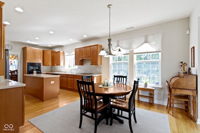 dining area with recessed lighting, light wood-style flooring, visible vents, and baseboards