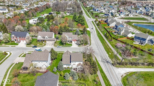 birds eye view of property featuring a water view and a residential view