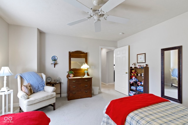 carpeted bedroom with baseboards and ceiling fan