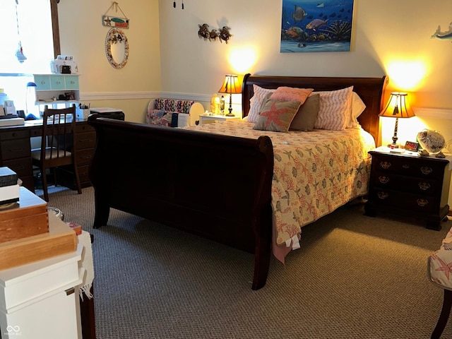 bedroom with carpet floors and wainscoting