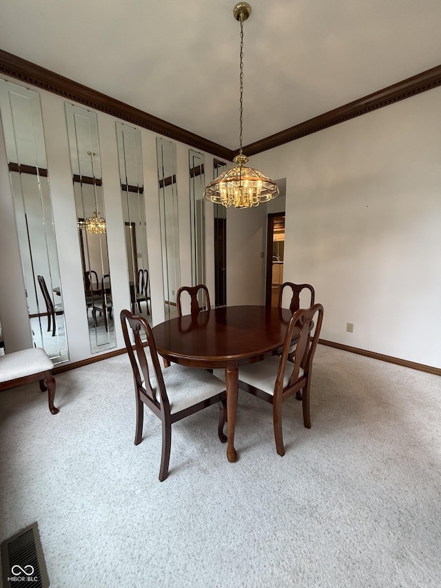 dining area with a chandelier, light carpet, ornamental molding, and visible vents