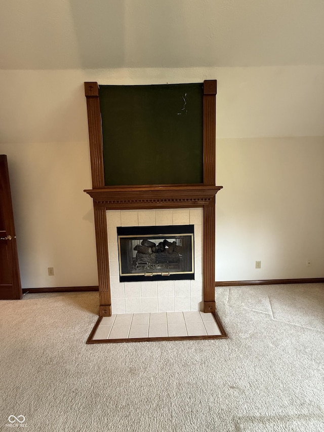 room details with baseboards, carpet, and a fireplace