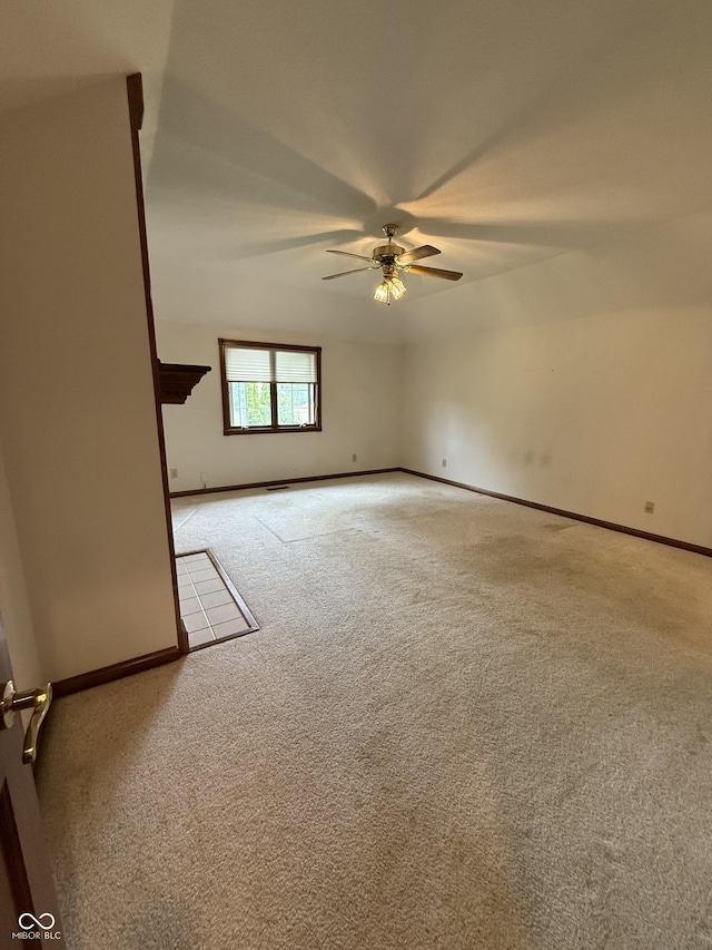 spare room with baseboards, ceiling fan, and carpet flooring
