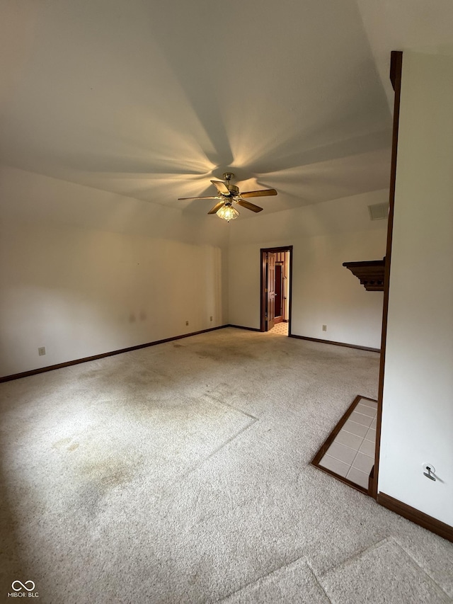 spare room with baseboards, a ceiling fan, carpet flooring, and visible vents