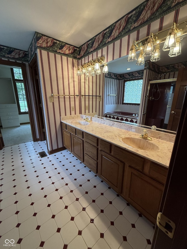 full bath featuring wallpapered walls, a chandelier, and a sink