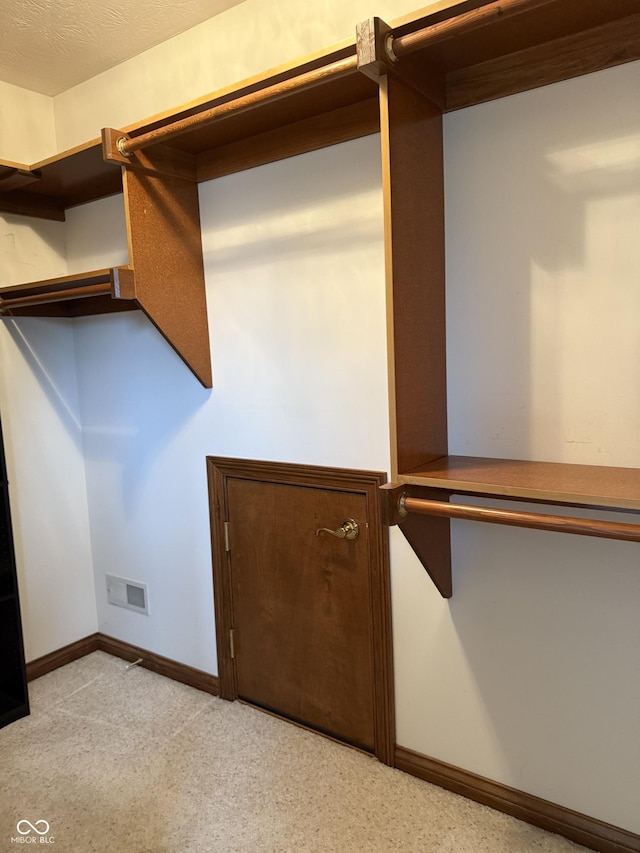 walk in closet with visible vents