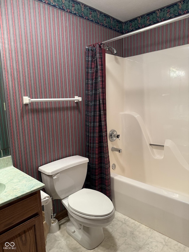 bathroom with vanity, marble finish floor, toilet, wallpapered walls, and shower / tub combo