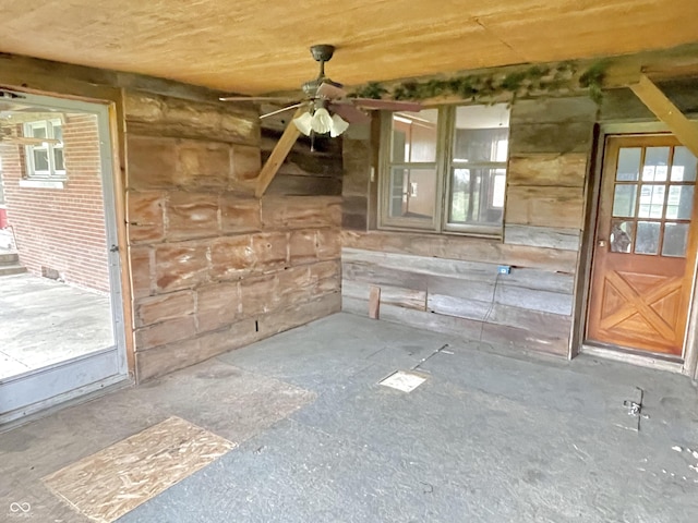 interior space with ceiling fan