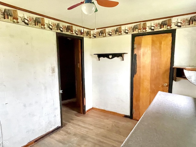unfurnished bedroom with baseboards, a ceiling fan, and wood finished floors