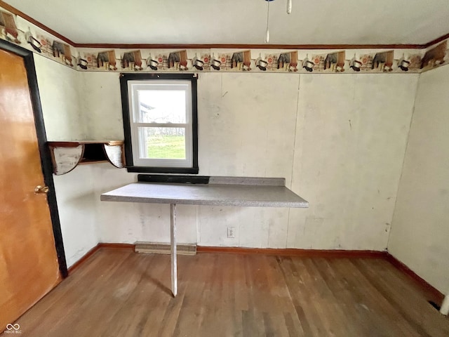 interior space featuring baseboards and wood finished floors