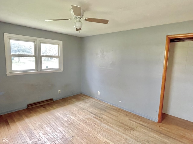 unfurnished bedroom featuring ceiling fan, visible vents, light wood-style flooring, and a closet