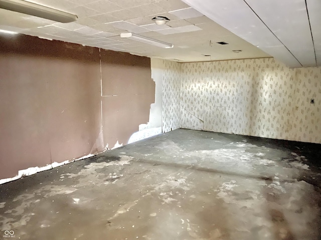 basement featuring wallpapered walls