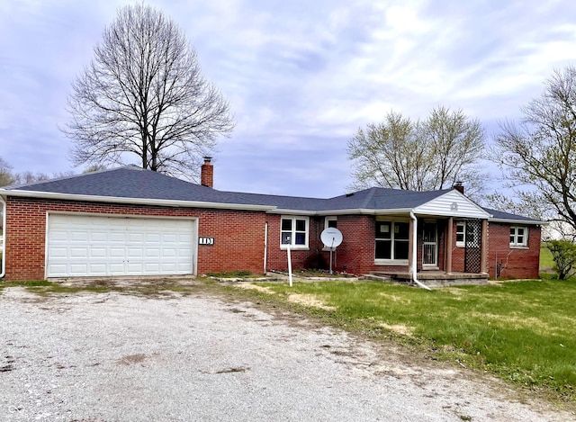 ranch-style house featuring a chimney, an attached garage, driveway, and brick siding