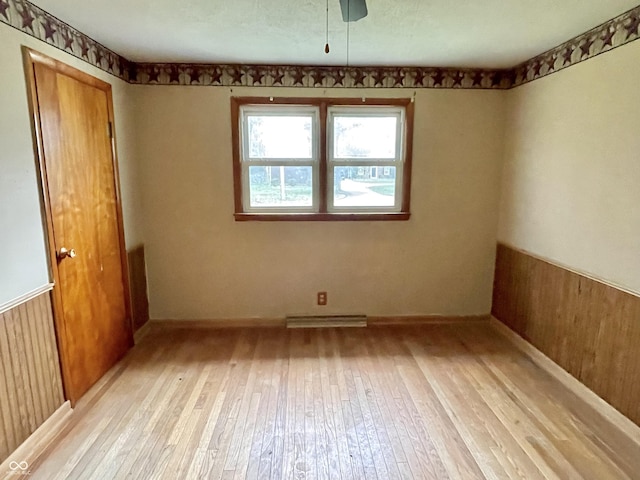 unfurnished room featuring light wood-type flooring and visible vents