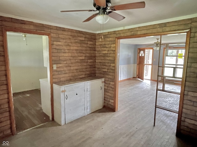 empty room featuring light wood finished floors and ceiling fan