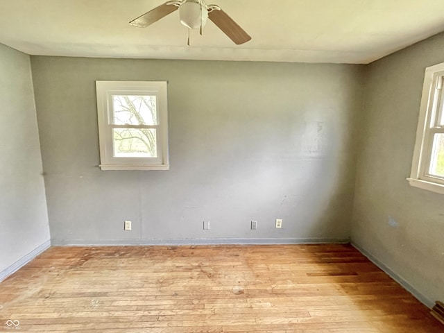 unfurnished room with ceiling fan, baseboards, and light wood finished floors