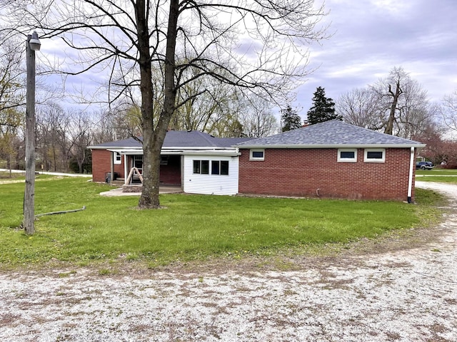 view of front of house with brick siding and a front lawn