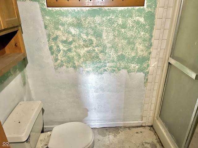 full bath with concrete floors, toilet, and a shower stall