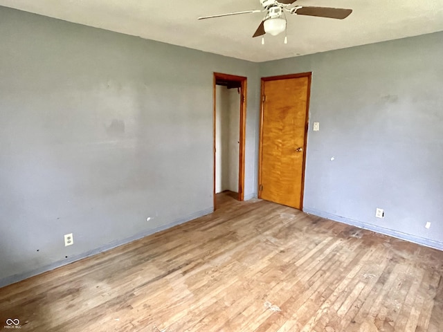 unfurnished room featuring a ceiling fan, baseboards, and light wood-style floors