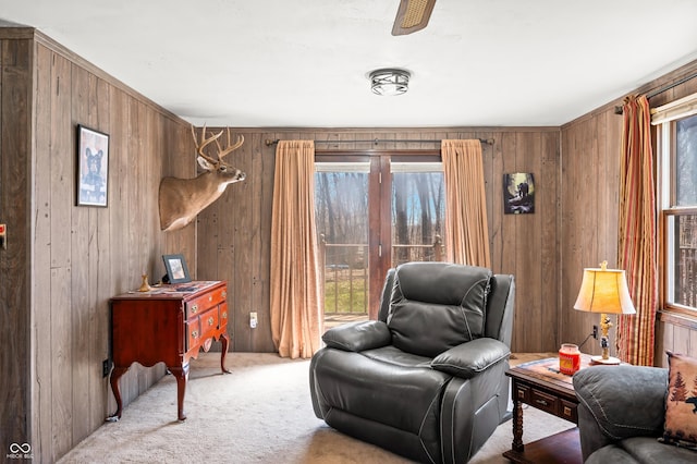 8847 E Northshore Dr, Unionville, IN 47468 - sitting room with wooden walls, ceiling fan, carpet, and a healthy amount of sunlight