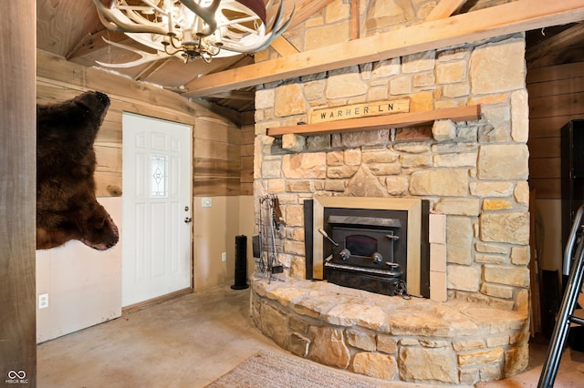 8847 E Northshore Dr, Unionville, IN 47468 - unfurnished living room with concrete flooring, a notable chandelier, and a fireplace