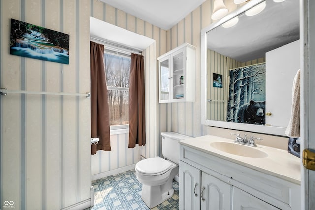 8847 E Northshore Dr, Unionville, IN 47468 - full bathroom featuring baseboards, toilet, vanity, wallpapered walls, and tile patterned floors