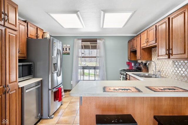 8847 E Northshore Dr, Unionville, IN 47468 - kitchen featuring light countertops, a peninsula, appliances with stainless steel finishes, and a sink