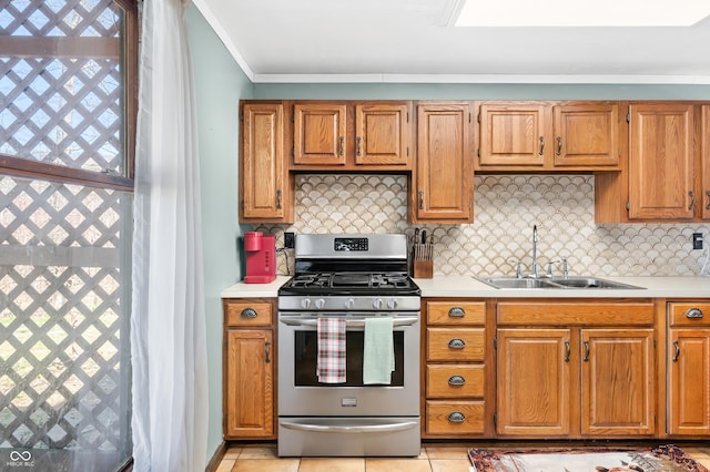 8847 E Northshore Dr, Unionville, IN 47468 - kitchen featuring stainless steel range with gas stovetop, a sink, ornamental molding, light countertops, and backsplash