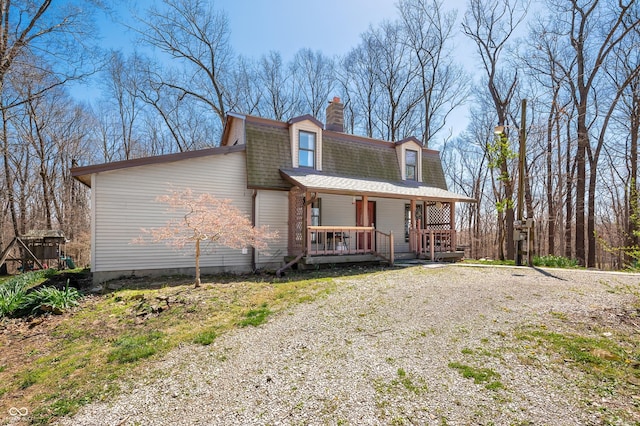 8847 E Northshore Dr, Unionville, IN 47468 - cape cod home featuring a chimney, driveway, a gambrel roof, a shingled roof, and covered porch