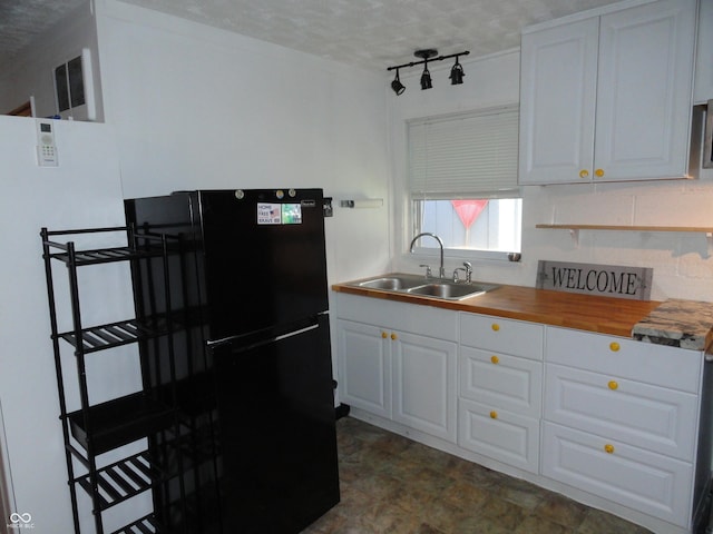 1722 N Parker Ave, Indianapolis, IN 46218 - kitchen with freestanding refrigerator, butcher block counters, and white cabinetry