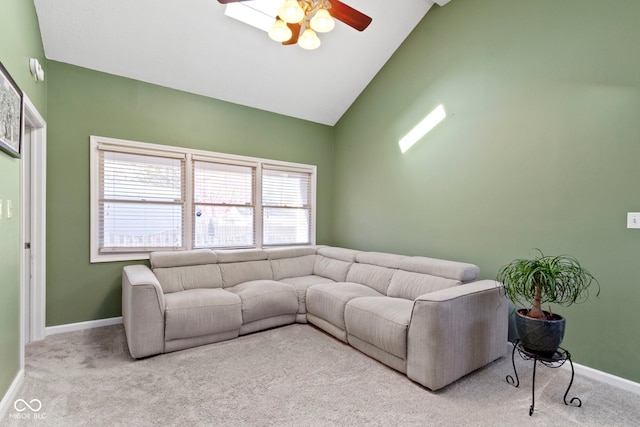 carpeted living area with a ceiling fan, baseboards, and high vaulted ceiling