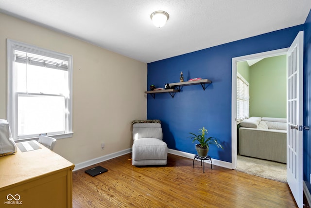 sitting room featuring wood finished floors and baseboards