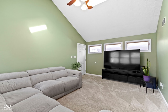 carpeted living area featuring visible vents, plenty of natural light, baseboards, and ceiling fan