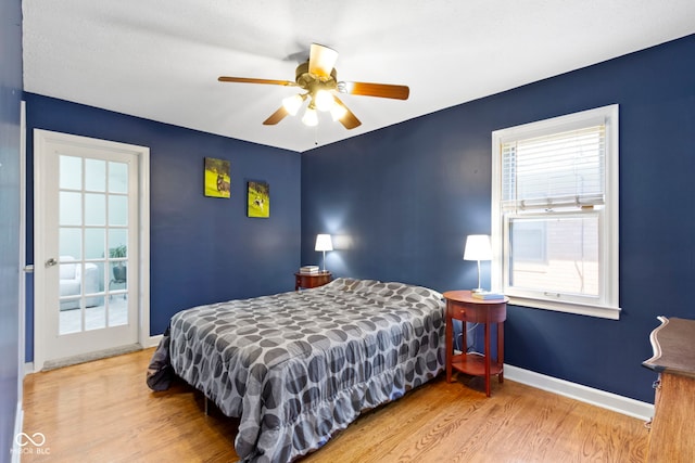 bedroom featuring wood finished floors, baseboards, and ceiling fan
