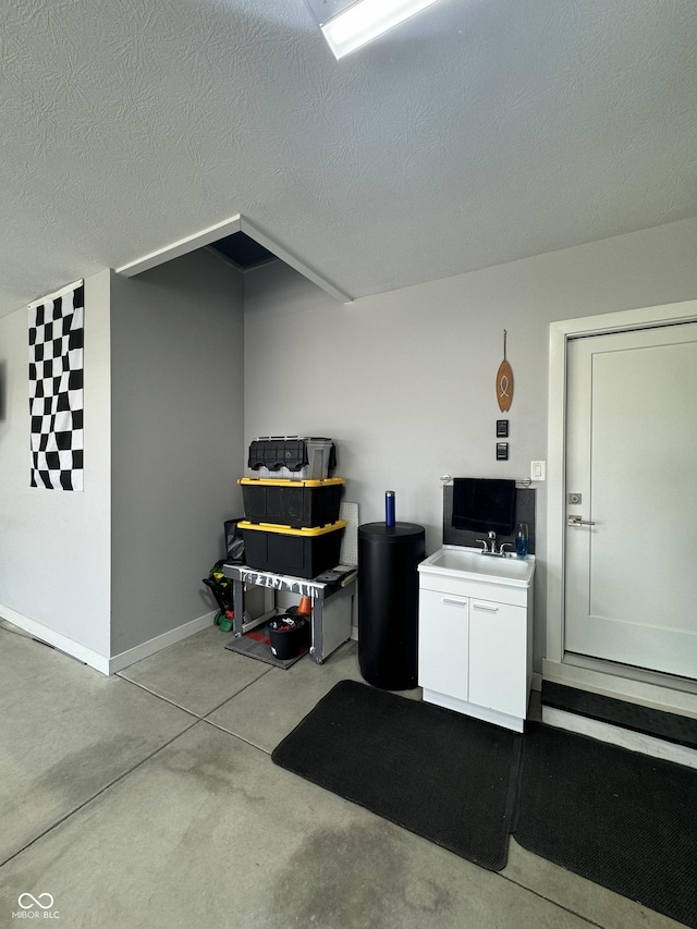 interior space with a sink and baseboards