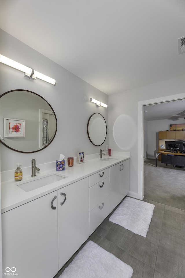 full bathroom featuring a sink and double vanity