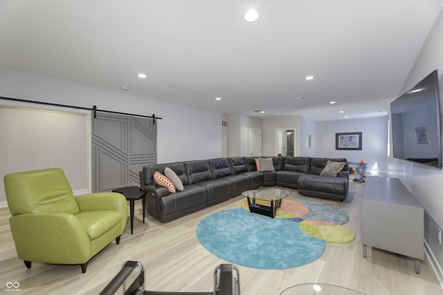 living area featuring recessed lighting, visible vents, a barn door, and light wood-type flooring