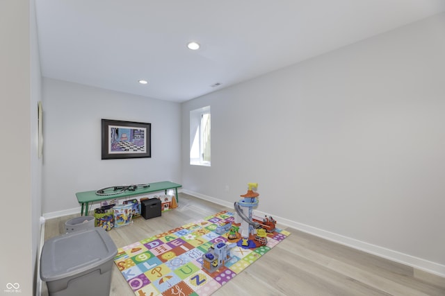 game room featuring recessed lighting, baseboards, and wood finished floors