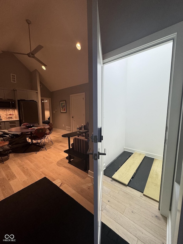 interior space featuring visible vents, wood finished floors, recessed lighting, a ceiling fan, and vaulted ceiling