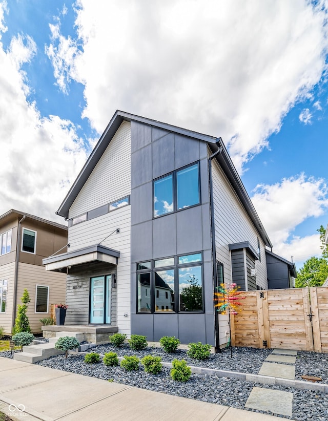 contemporary house with fence and a gate