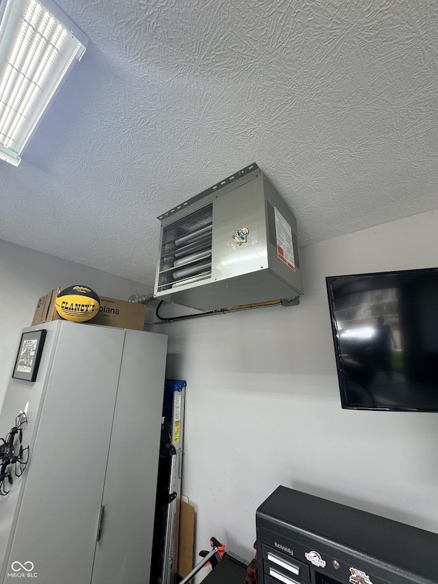 room details featuring a heating unit and a textured ceiling