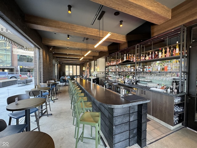 bar with wet bar, beam ceiling, and decorative light fixtures
