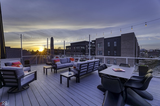 deck at dusk with an outdoor living space