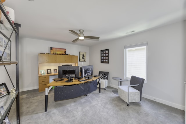 home office featuring visible vents, baseboards, ceiling fan, and light colored carpet