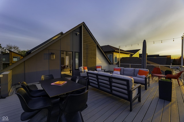 wooden deck with outdoor dining area and an outdoor living space with a fire pit
