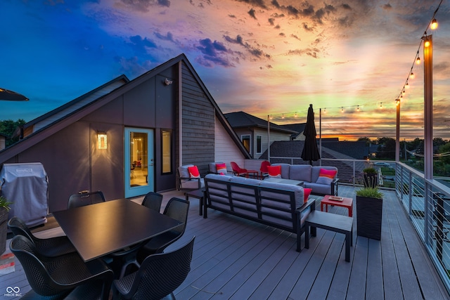 wooden terrace featuring an outdoor living space, outdoor dining space, and a grill